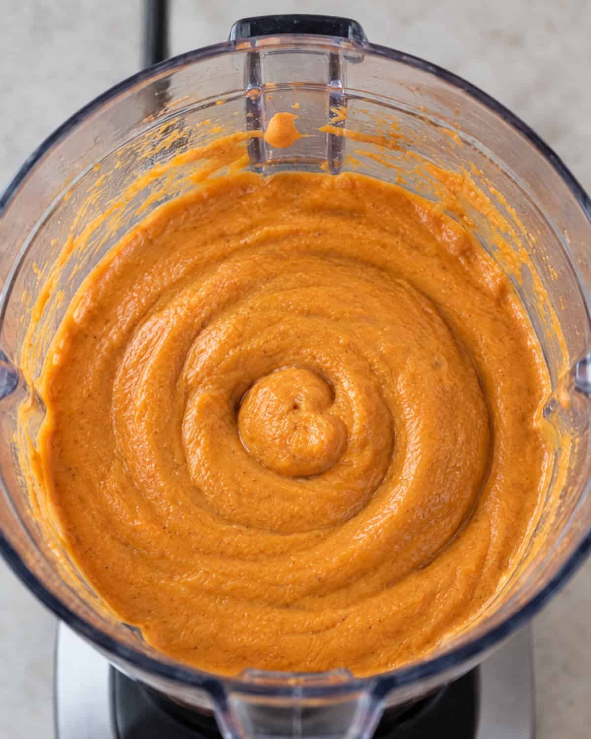 Wet ingredients for sweet potato chocolate muffins mixed in a food processor.