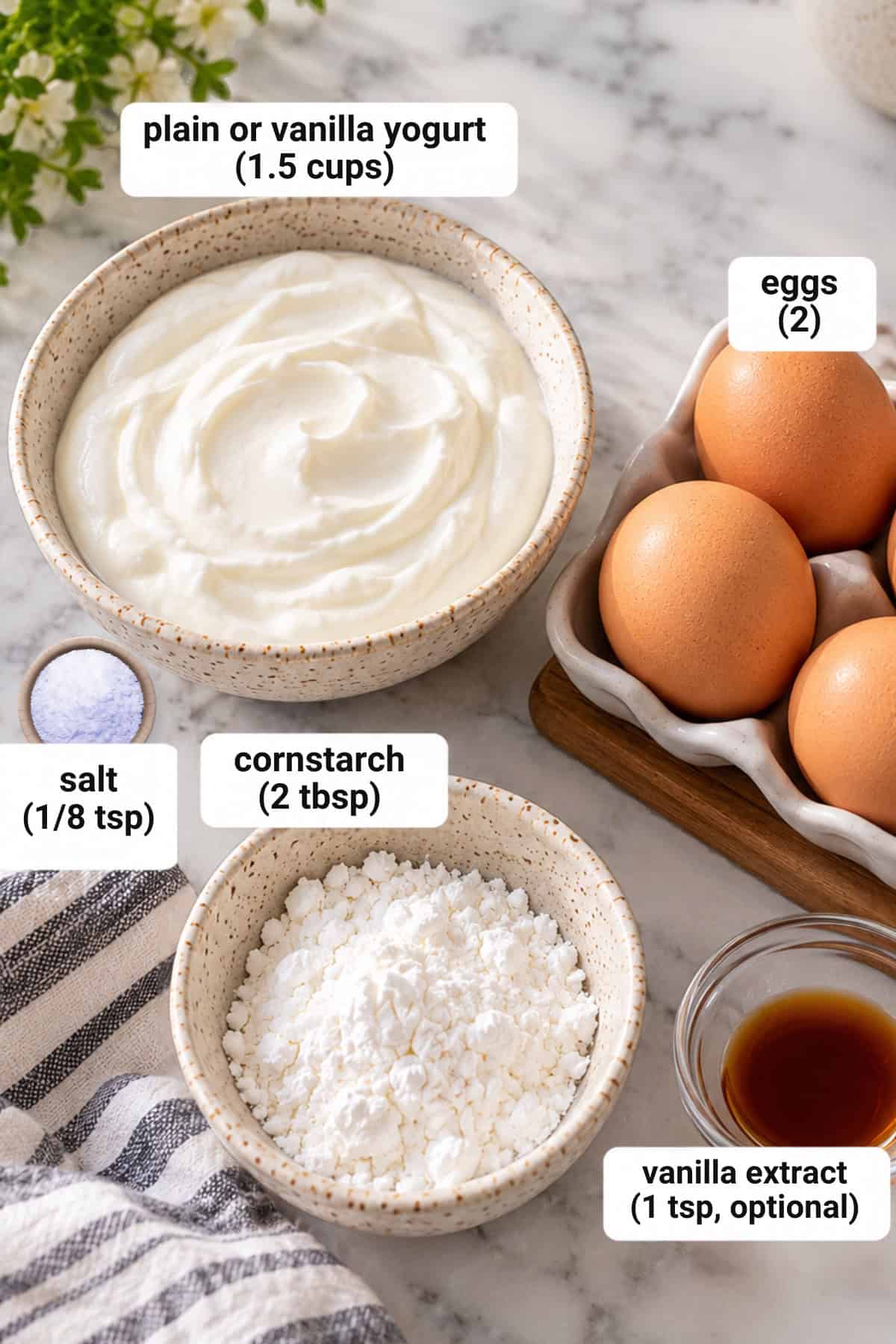 Ingredients for healthy cheesecake recipe on a marble countertop.